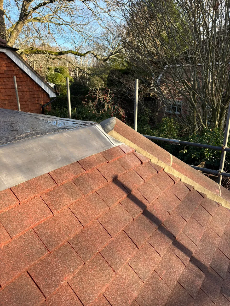 Leadwork junction between a flat roof and tiled hip
