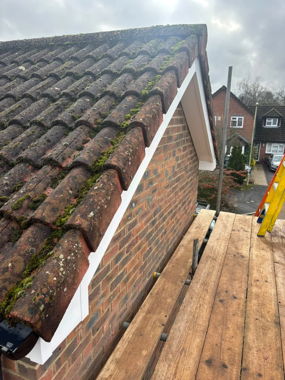 New white uPVC bargeboard along a tiled roof edge