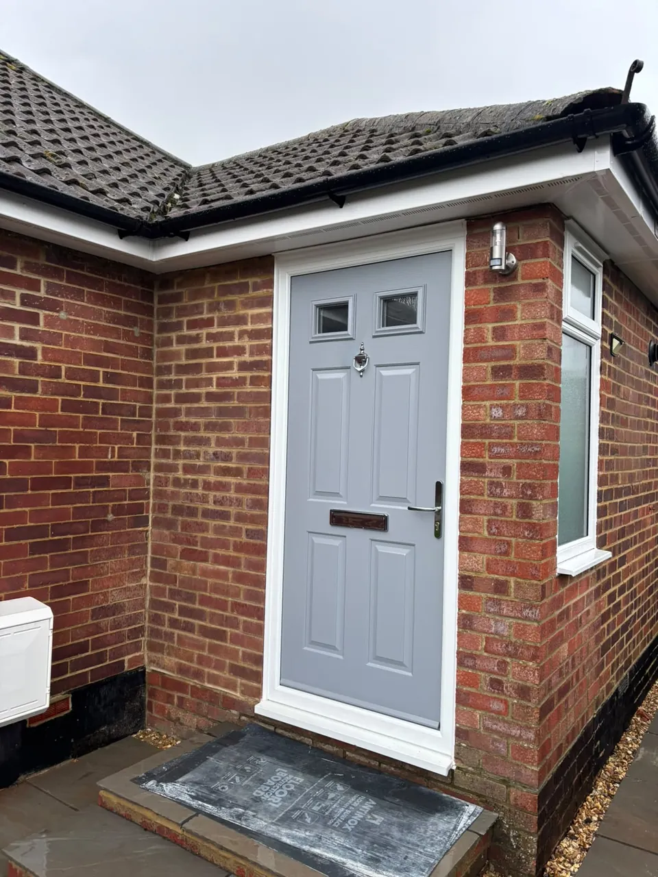 White uPVC soffit around a brick house entrance