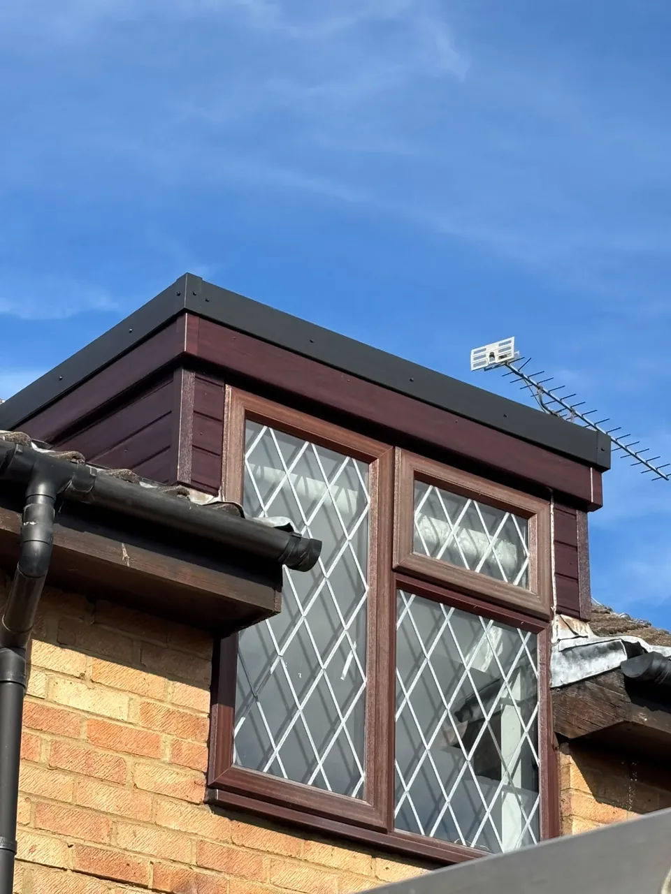 Finished dormer roof with dark uPVC cladding and trims