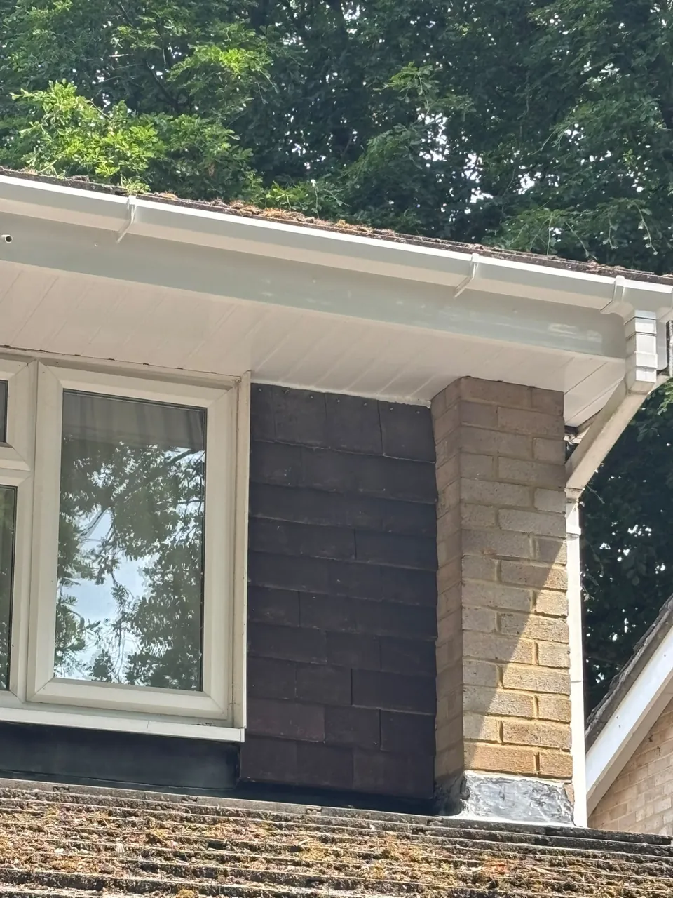 White uPVC soffit above a clad wall and window