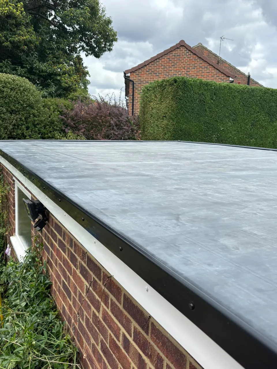 EPDM rubber garage roof with new edge trims