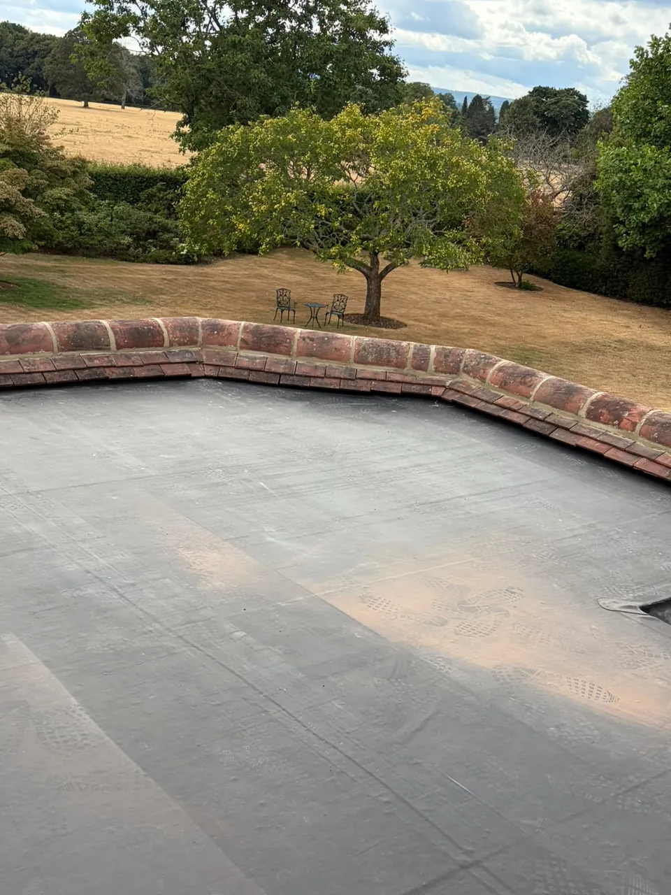 New grey EPDM flat roof on a single-storey extension