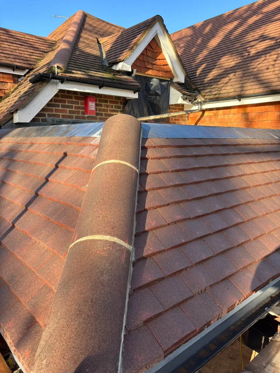 Tiled roof hip with neat detailing after re-roofing